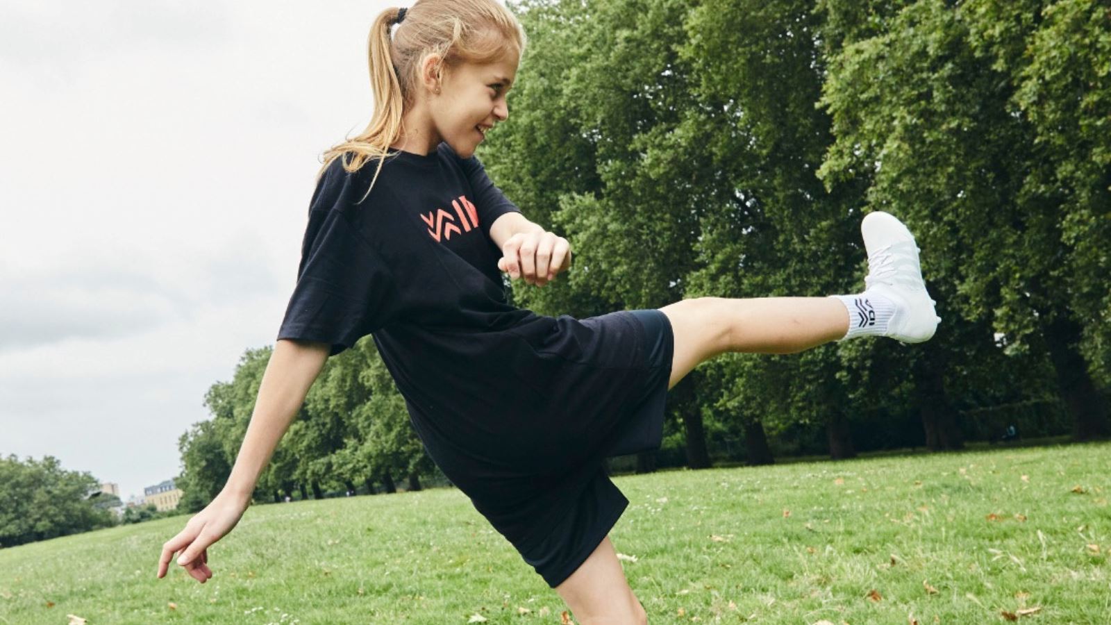 Youth girls soccer player wearing IDA women's soccer cleats